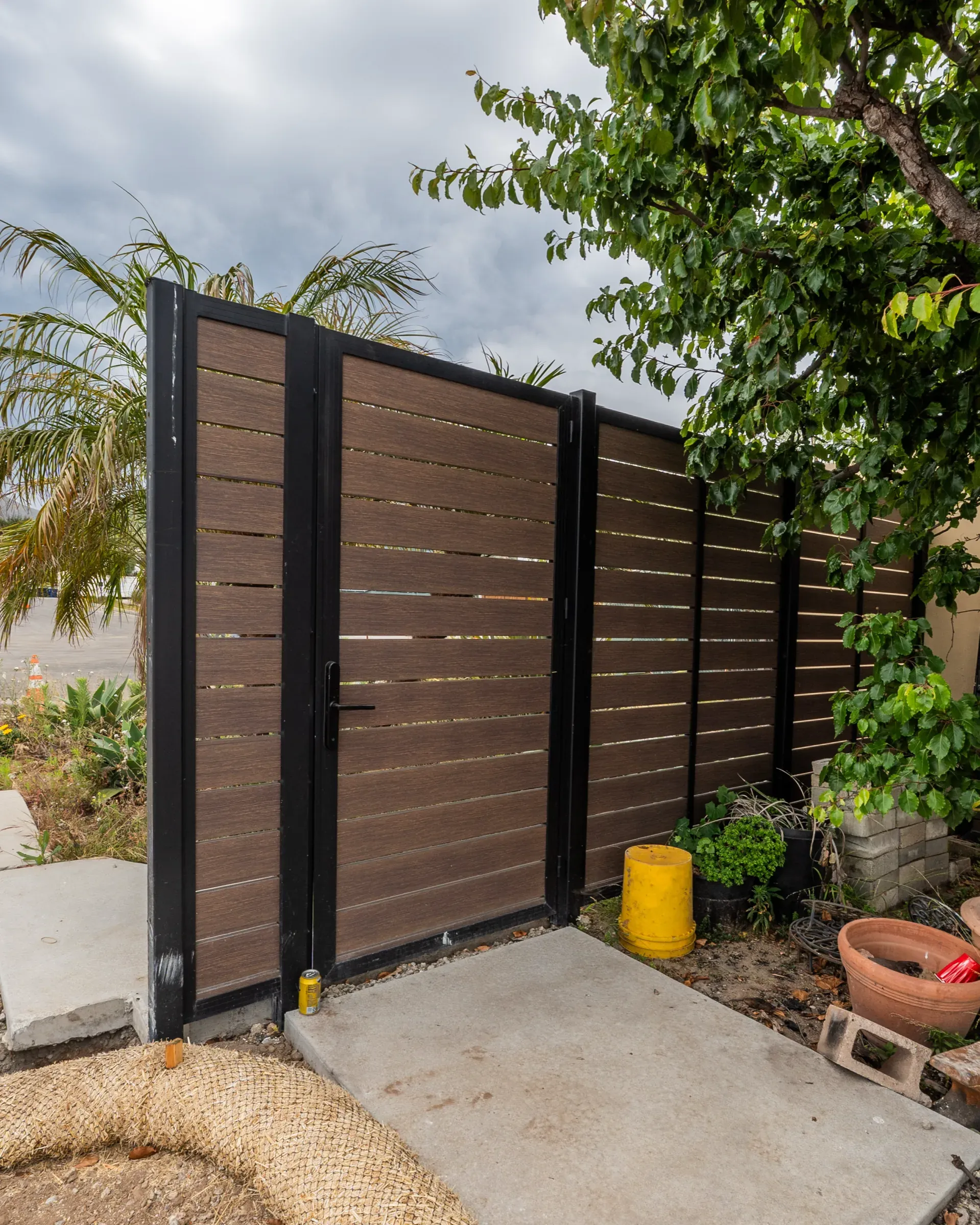 A Mulholland wood-look aluminum gate and matching fence, timber appearance without the fire risk