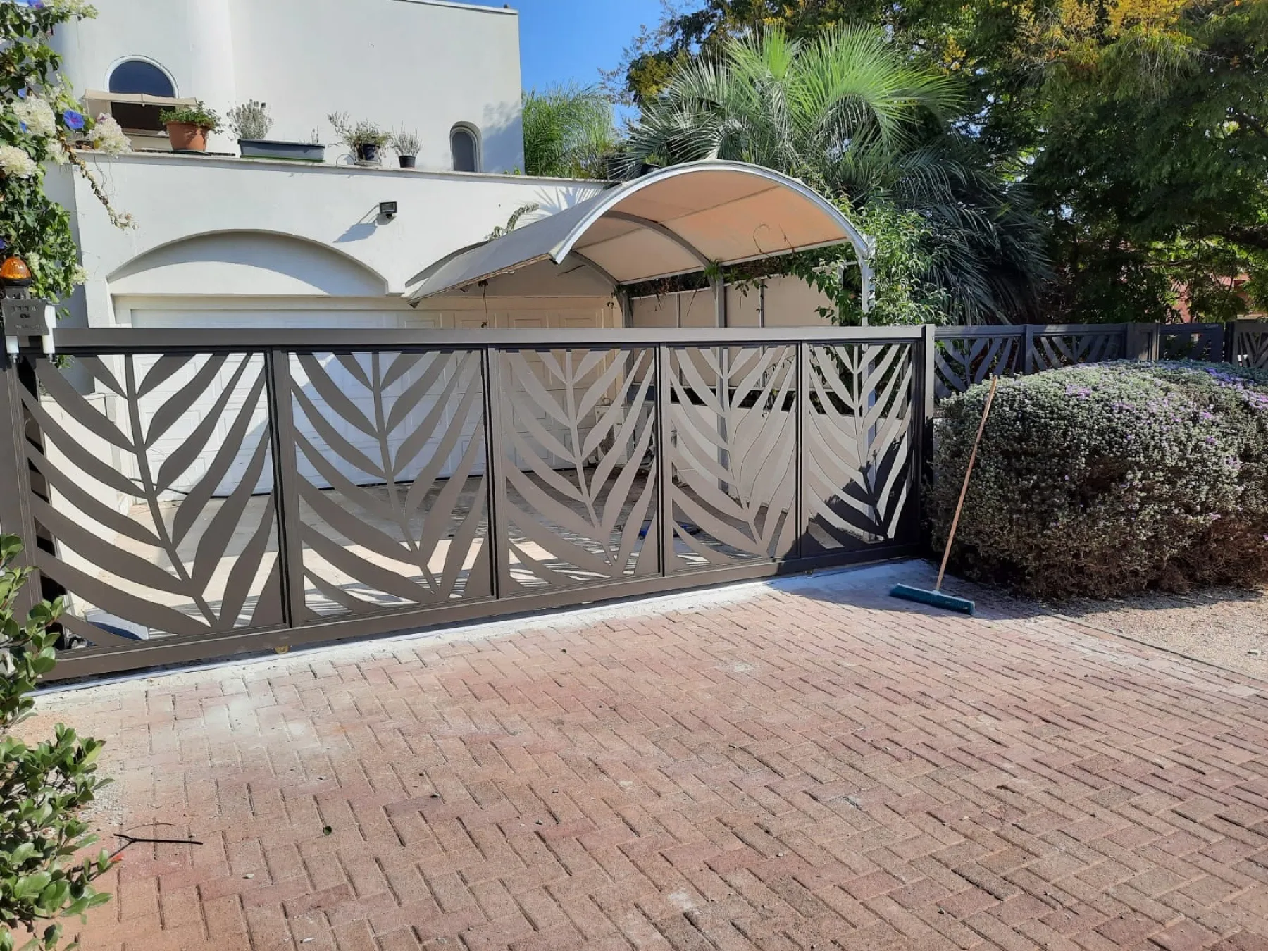 Black Laser-Cut Driveway Gate, installed by Mulholland Brand