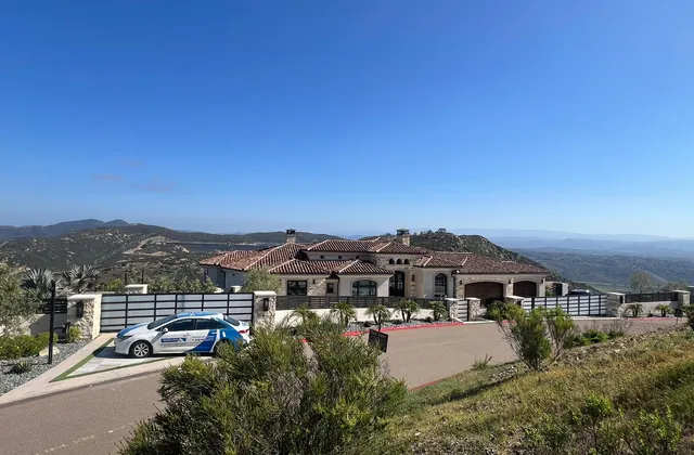 Aluminum driveway gate at a hillside estate
