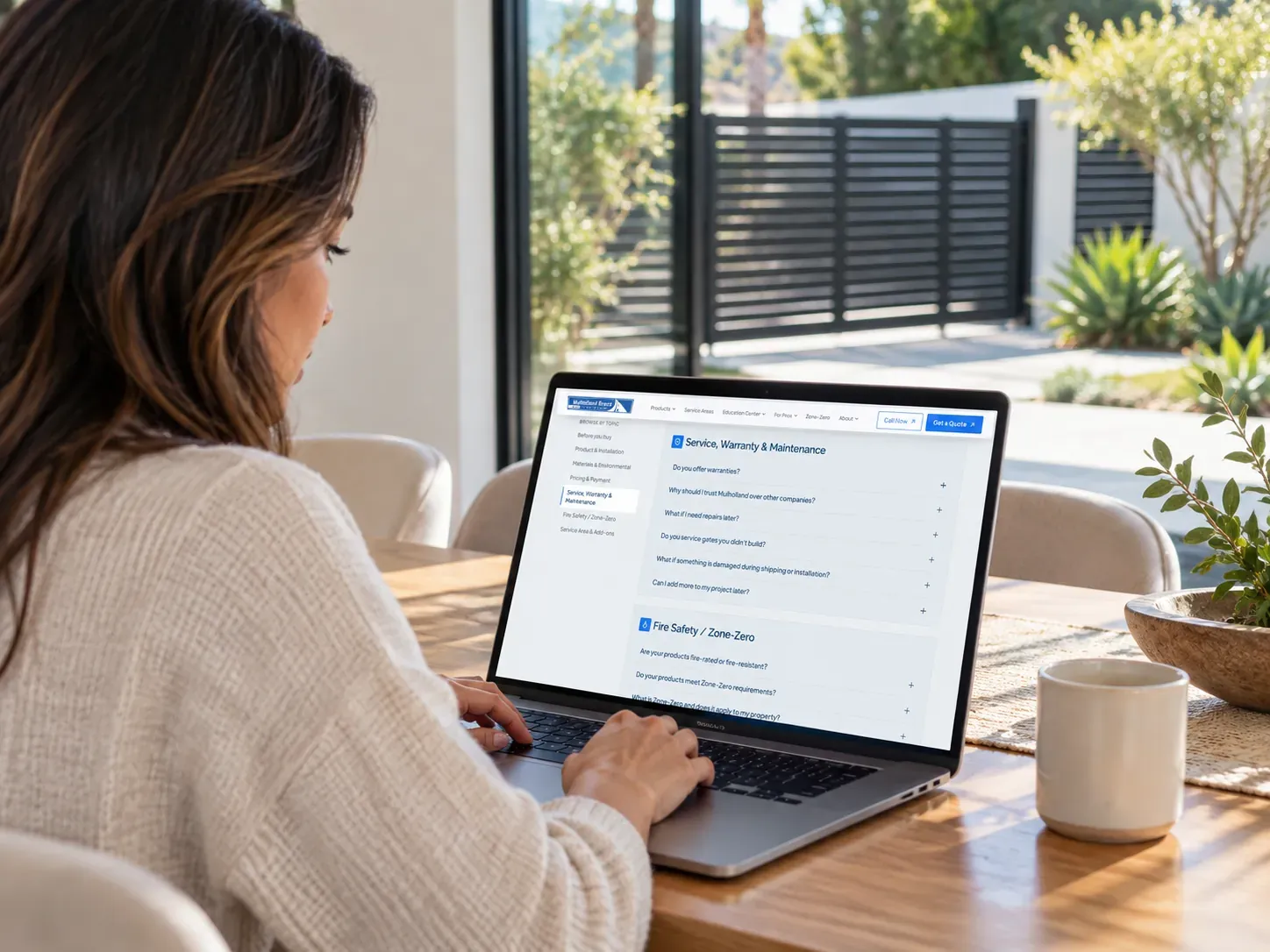 A homeowner reading Mulholland's service and warranty answers on a laptop