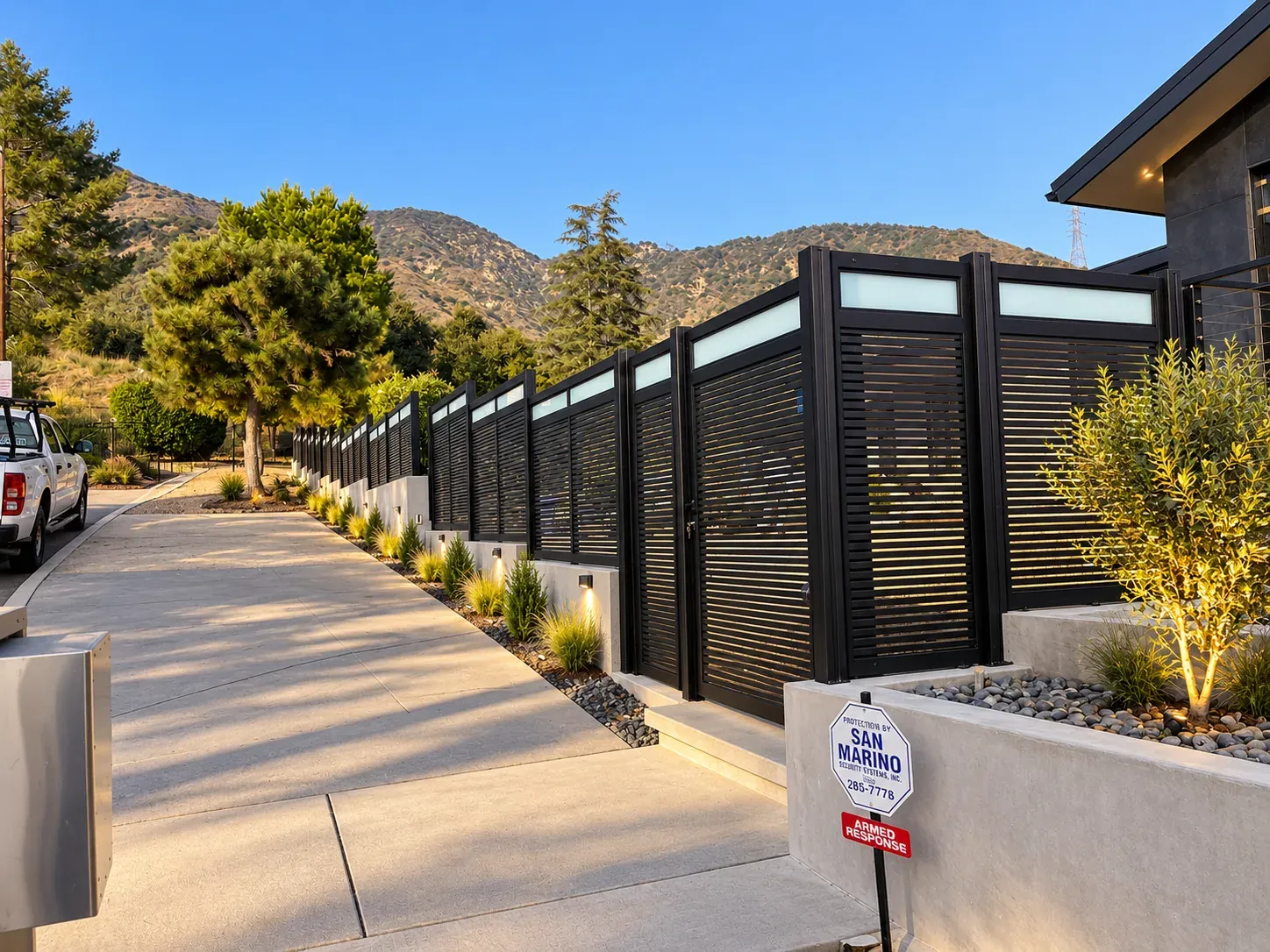 Mulholland aluminum gates and slat fencing on Southern California homes, at street level and at dusk