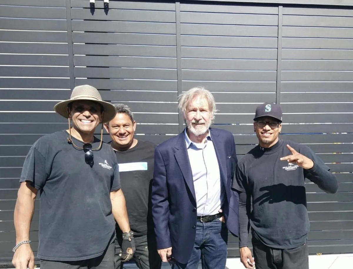 Harrison Ford with the Mulholland Brand crew in front of a Mulholland gate