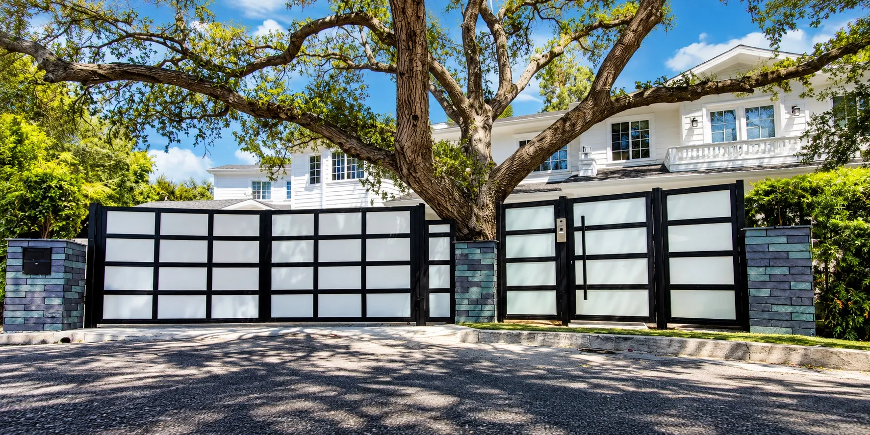 A Mulholland black aluminum gate with white glass panels