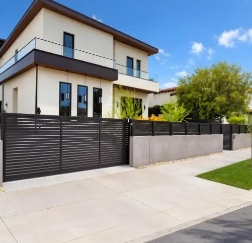 Black horizontal-slat aluminum fence and sliding gate in front of a two-storey modern home