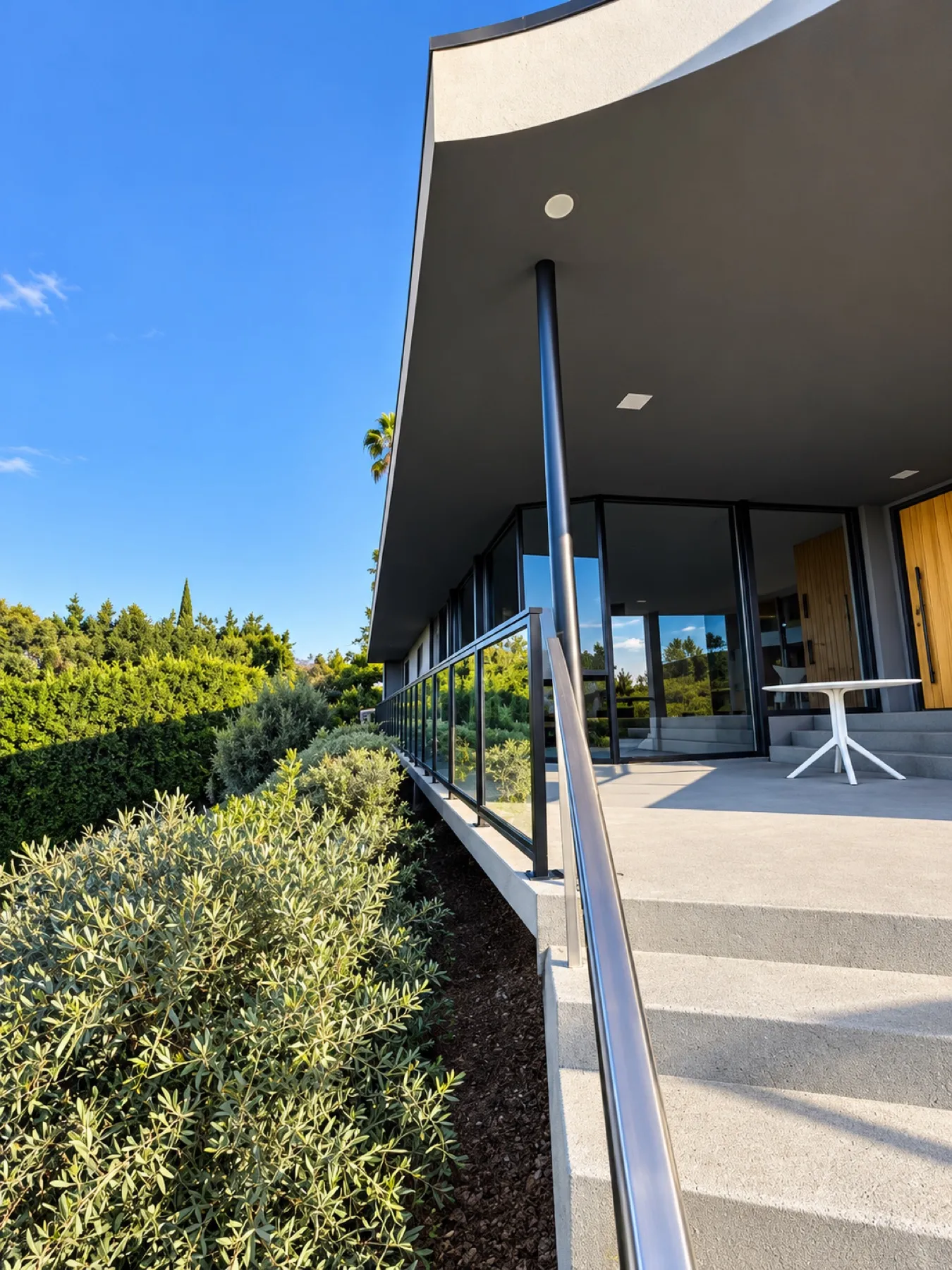 Black-framed glass railing installed by Mulholland Brand