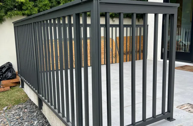 Dark aluminum railing around a raised terrace