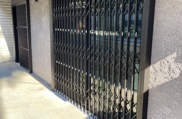 Retractable aluminum security bars across a doorway