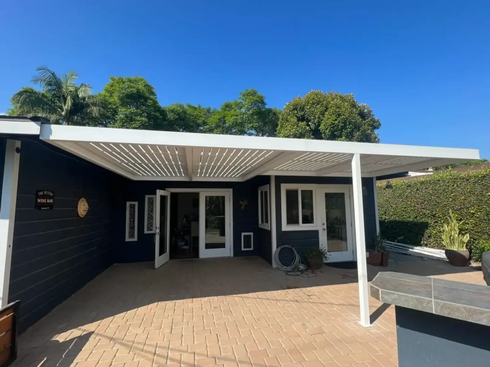 Aluminum pergola installed by Mulholland Brand