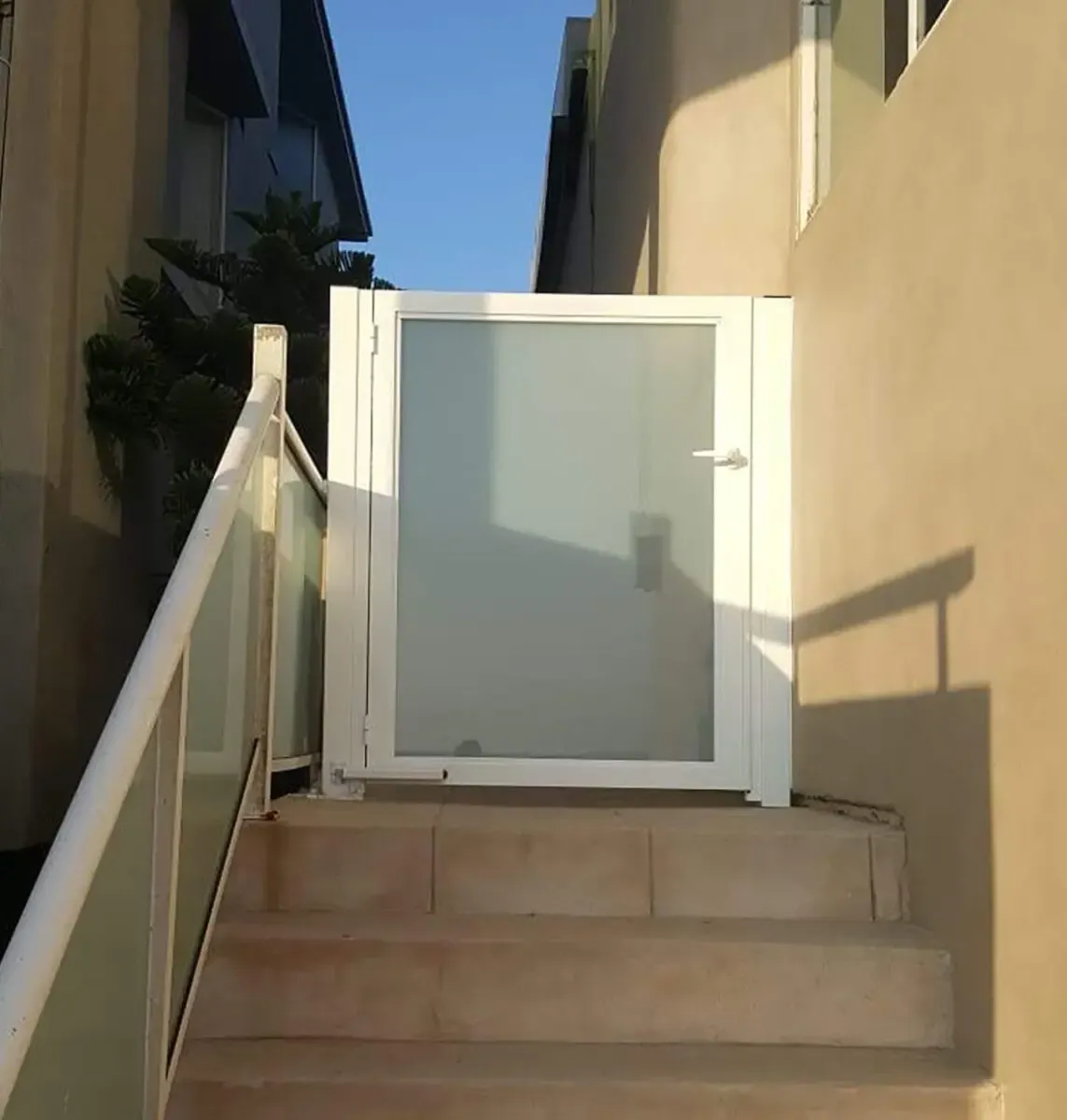 White aluminum and glass entry gate