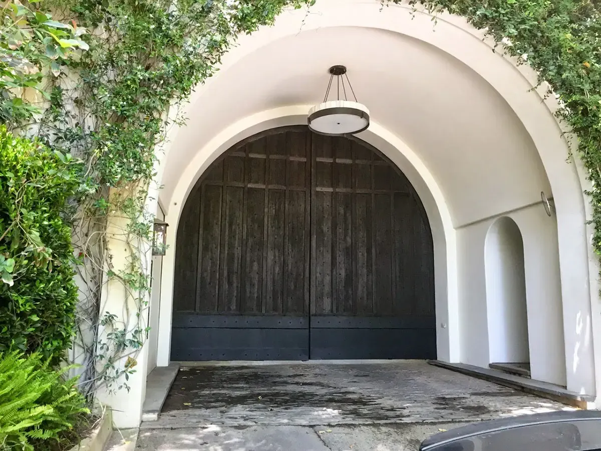 Dark wood gate in arched entry way