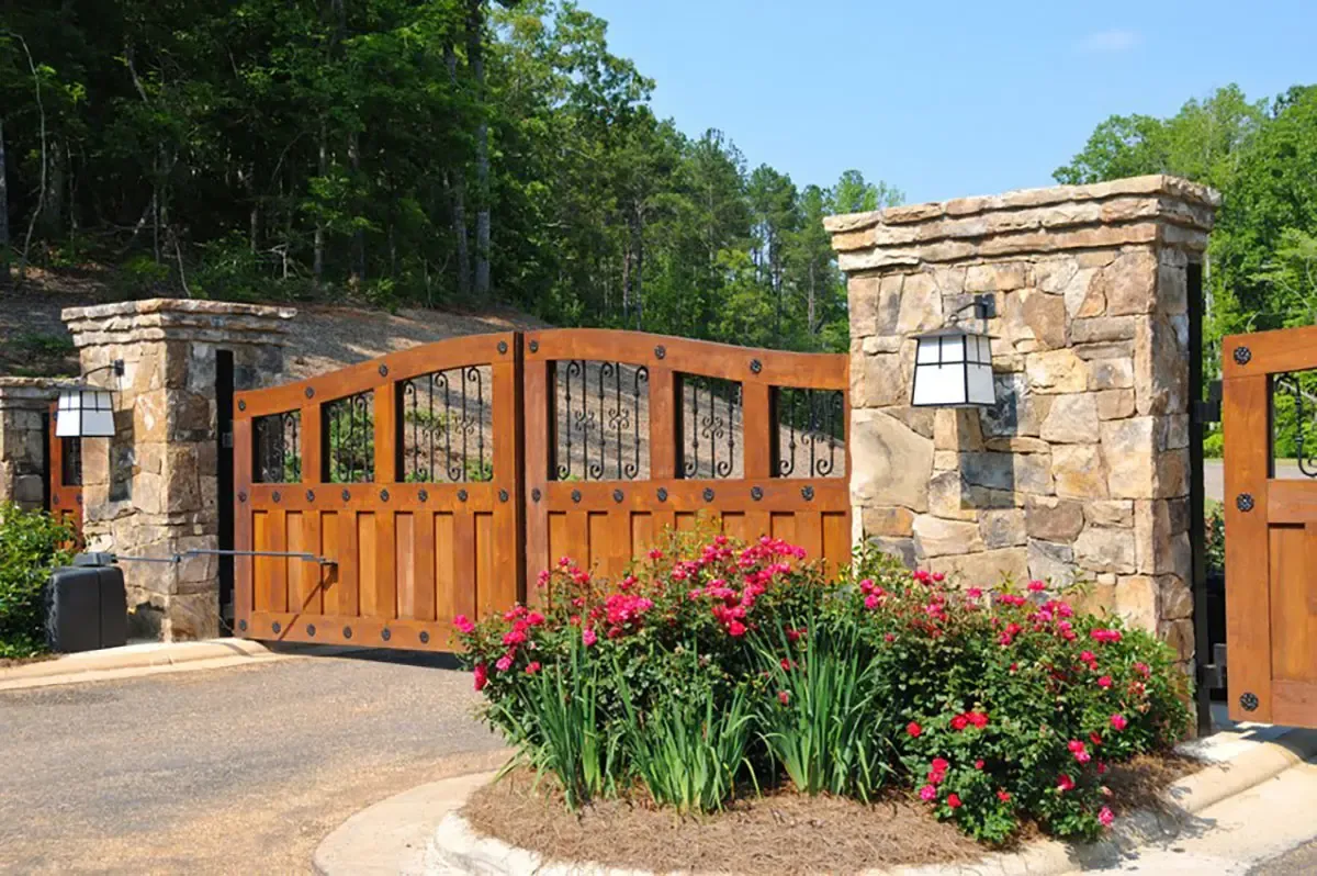 Wood driveway gate with iron accents