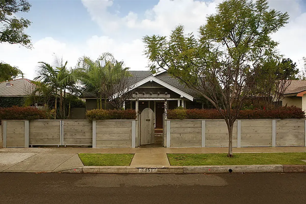 Light-colored wood fence with entryway