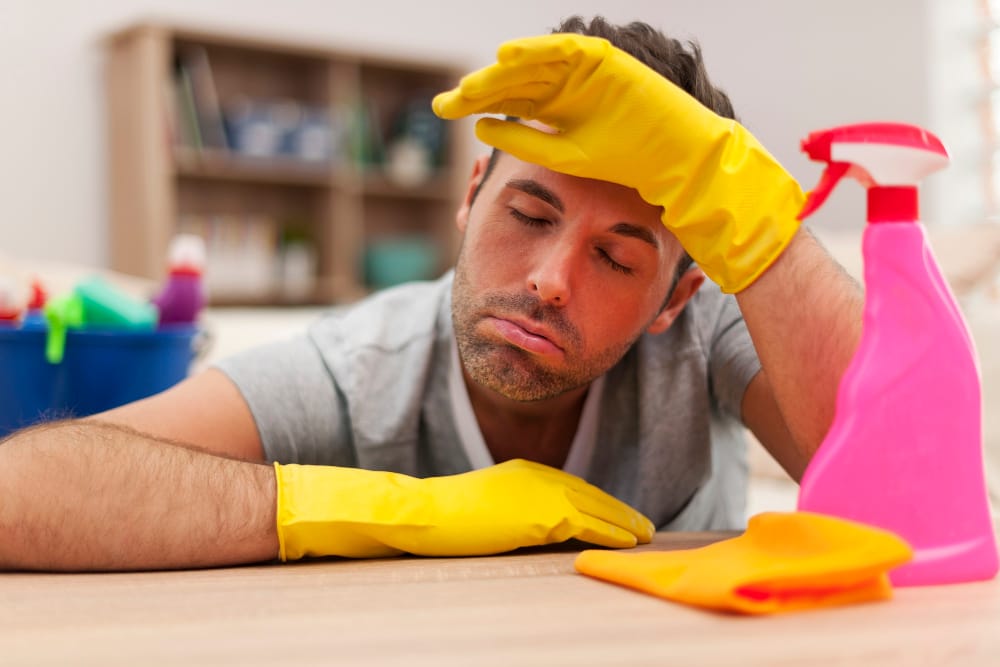 tired man with cleaning equipment