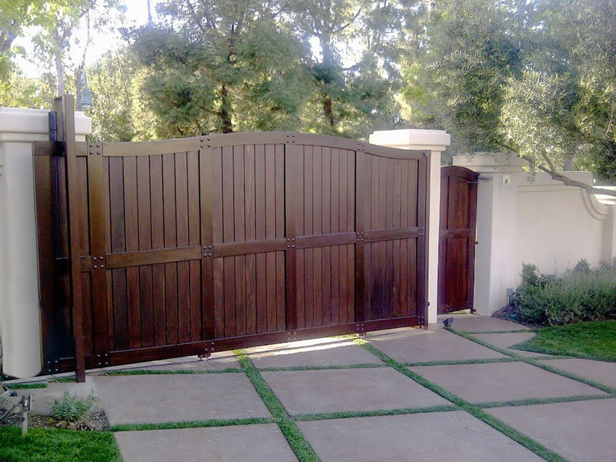 Dark wood driveway gate with side entry