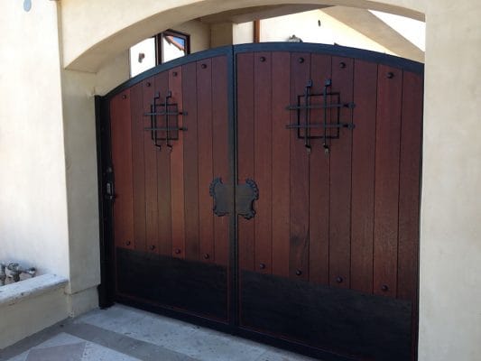 Dark wood entry gate with iron accents