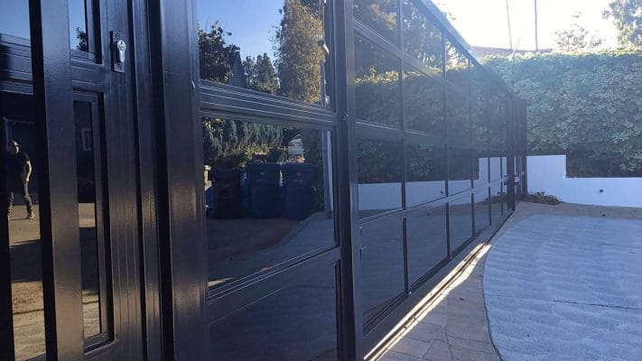 Black aluminum and glass driveway gate