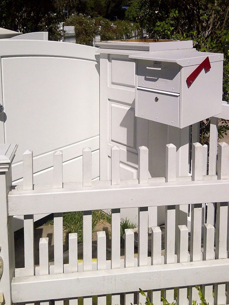 White gate surrounding mailbox