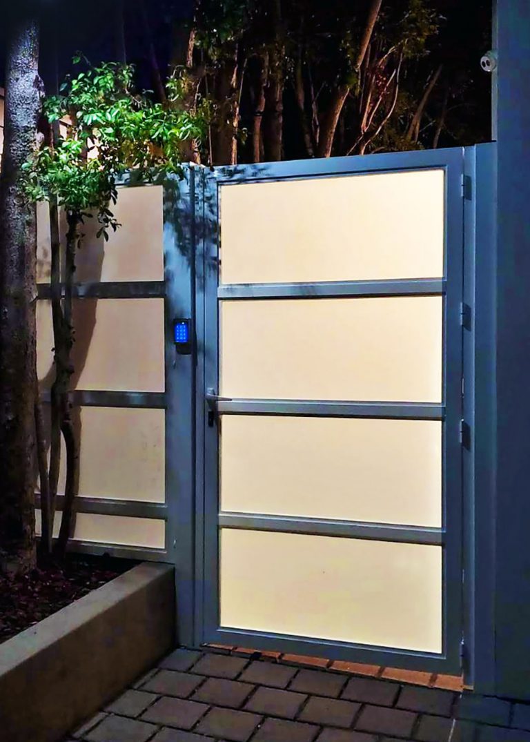 Gray aluminum and glass side entry way at night