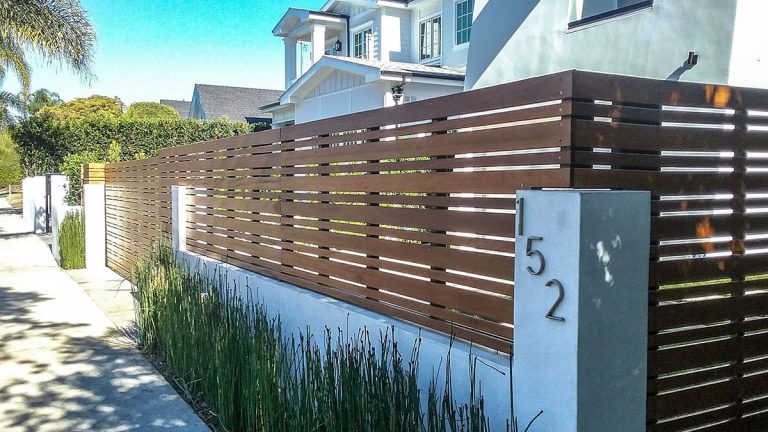 Horizontal slated wood driveway gate and fence
