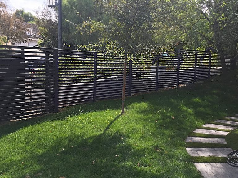 Horizontal slated iron perimeter fence