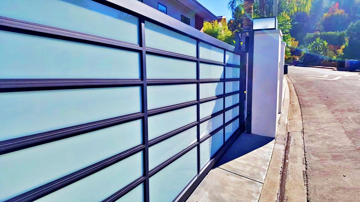 Black aluminum and blue glass driveway gate