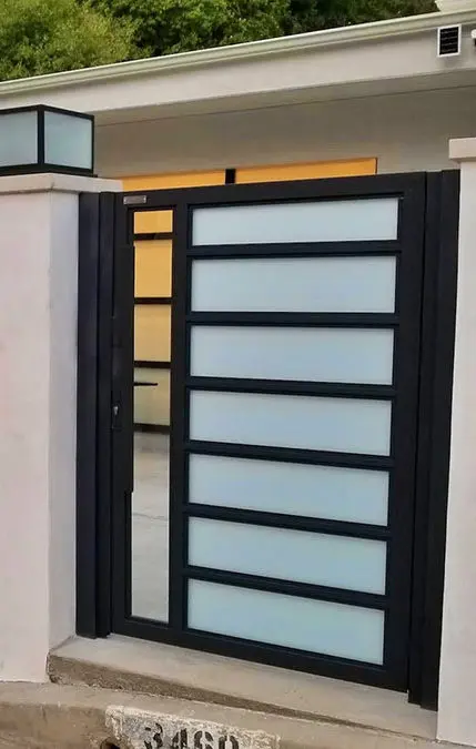 White aluminum and glass driveway gate