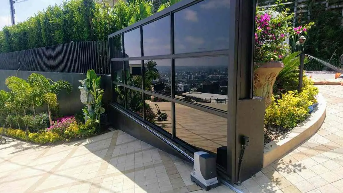 Black aluminum and black glass driveway gate
