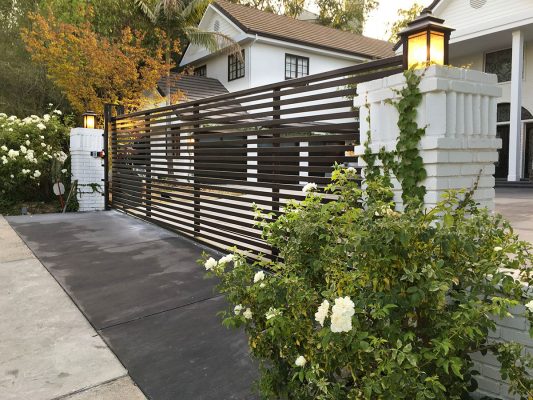 Iron driveway gate with horizontal slats