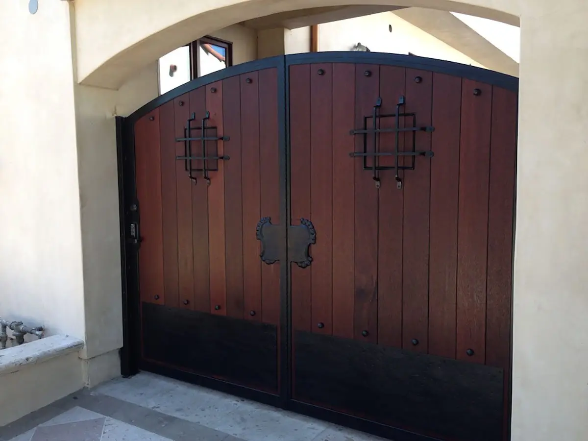 Dark wood entry gate with iron accents