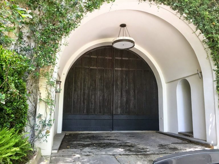 Dark wood gate in arched entry way