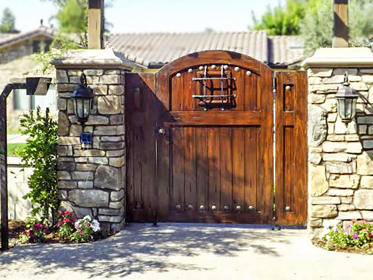 Wood driveway gate with steel accents