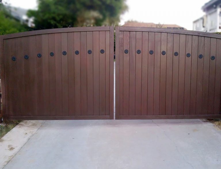 Wood driveway gate with iron accents