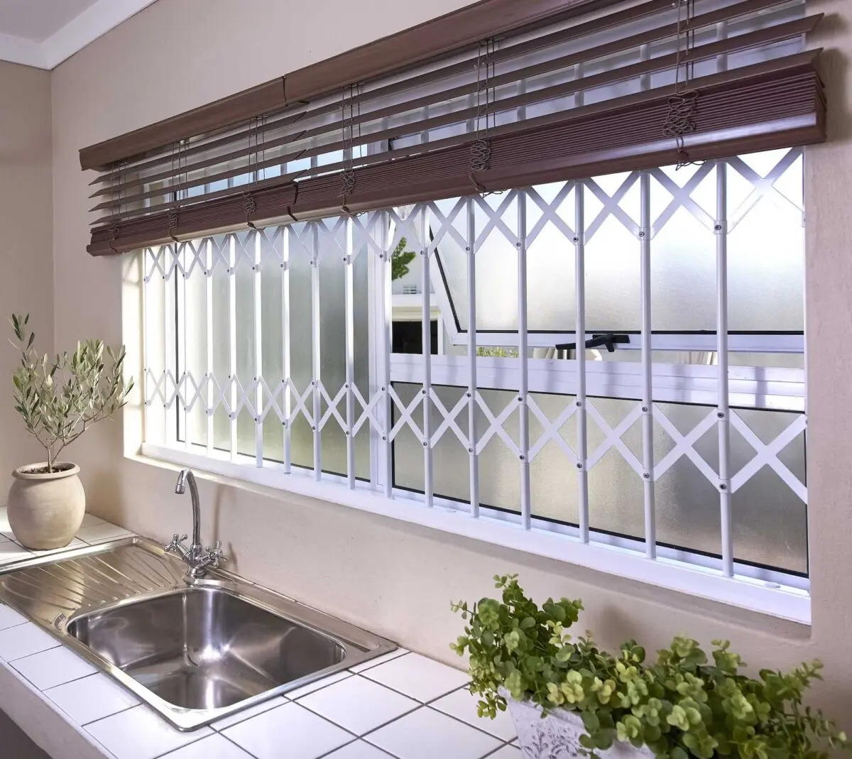 White retractable bars across a kitchen window