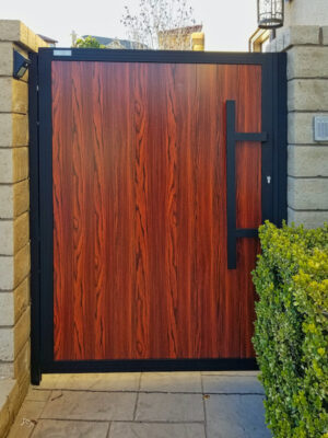 a woodlike pedestrian gate with vertical slats