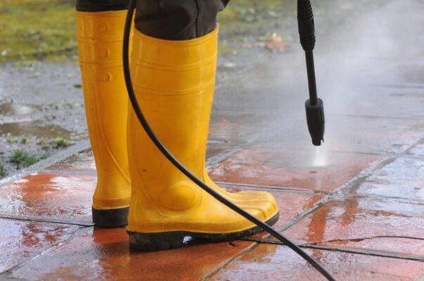person wearing pressure cleaning boots