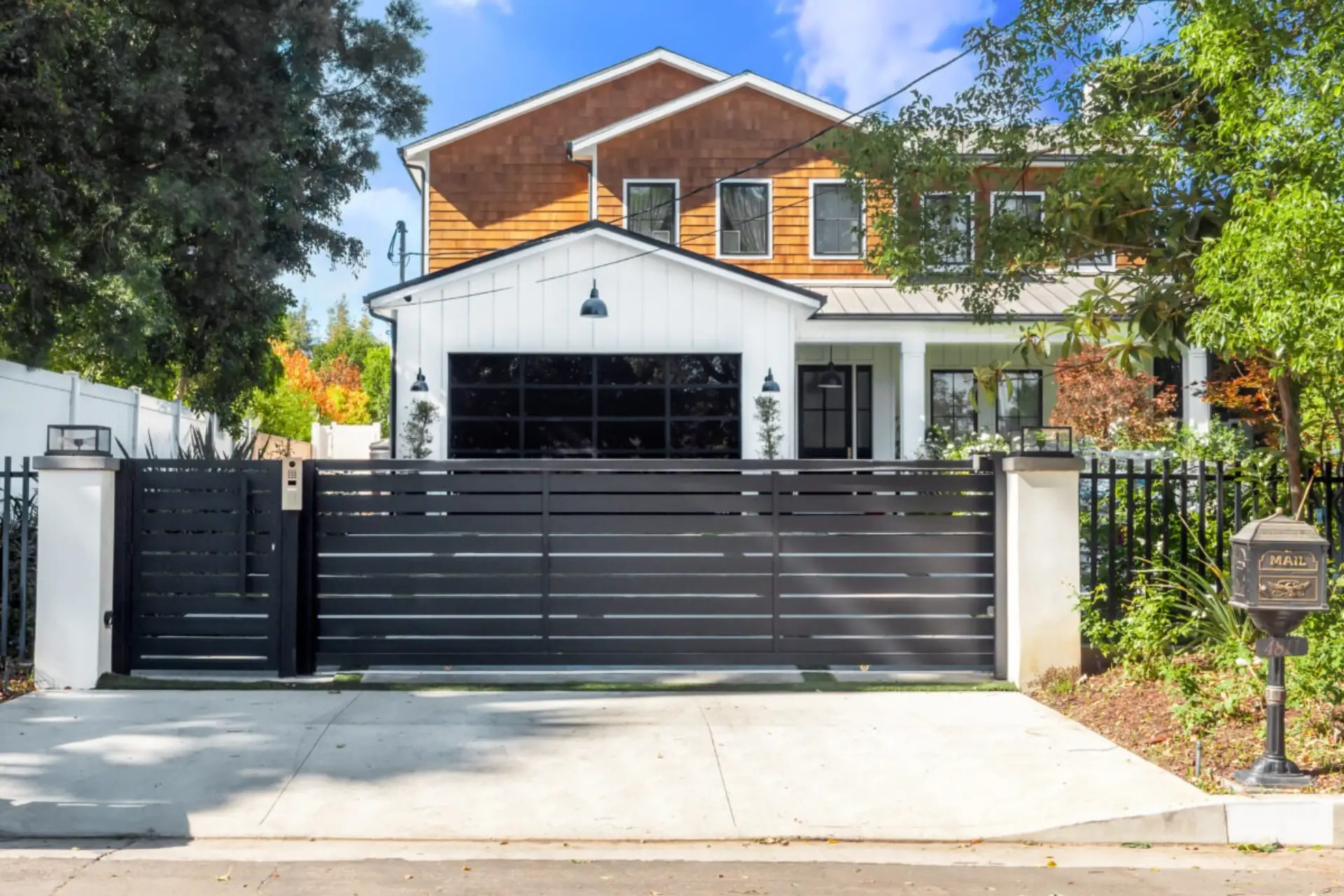 Modern house with black aluminum gate and garage door